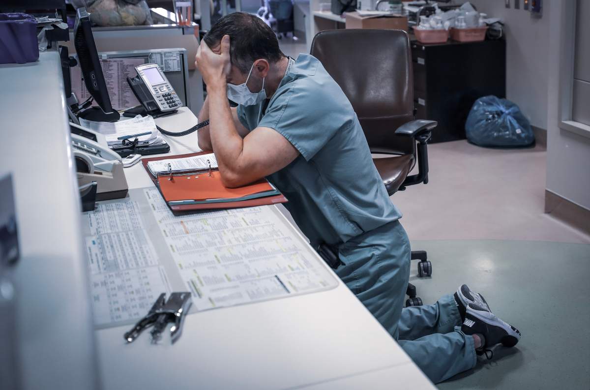 Physician Dr. Simon Demers-Marcil in the ICU Unit at Peter Lougheed Centre in Calgary, Alta., on the phone telling a family their loved one had died of COVID-19.