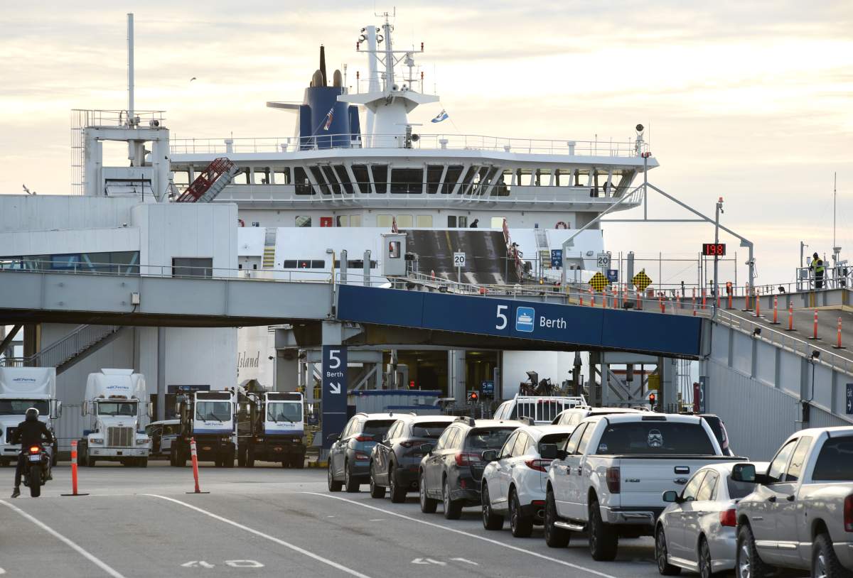 A view of traffic, including cars, trucks and motorcycles, waiting to board a ferry at the BC Ferries terminal at Tsawwassen, British Columbia on October 25, 2020.