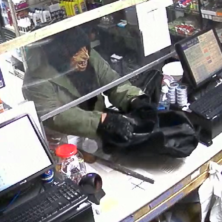 The masked suspect caught on camera during the robbery.
