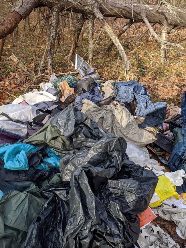 The Ministry of Natural Resources and Forestry are looking for tips on who might be illegally dumping garbage at a Gananoque wildlife area. 