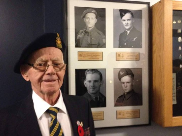 Second World War veteran, Timer Hyndman, 95, stands in front of service photos of he and his brothers. Hyndman marked Remembrance Day differently Wednesday, as COVID-19 forced the cancellation of ceremonies across Canada.