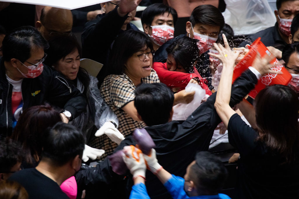 Kuomintang (KMT) legislators throw pig offal on the podium in Taiwan parliament in Taipei, Taiwan, on Nov. 27, 2020.