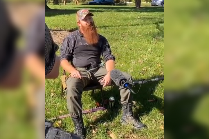 An armed man identified by police as Justin Dunn is shown outside a polling station in Charlotte, N.C., on Nov. 3, 2020.