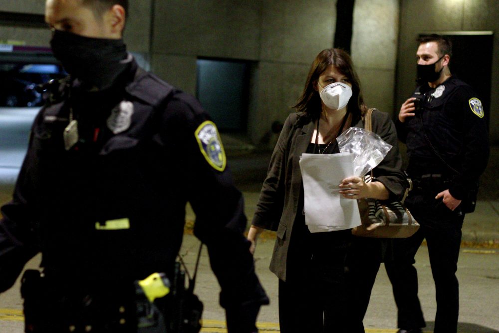 Milwaukee Election Commission Executive Director Claire Woodall-Vogg delivers flash drives with absentee voter tallies from a central count location to Milwaukee County election officials on early Wednesday, Nov. 4, 2020.