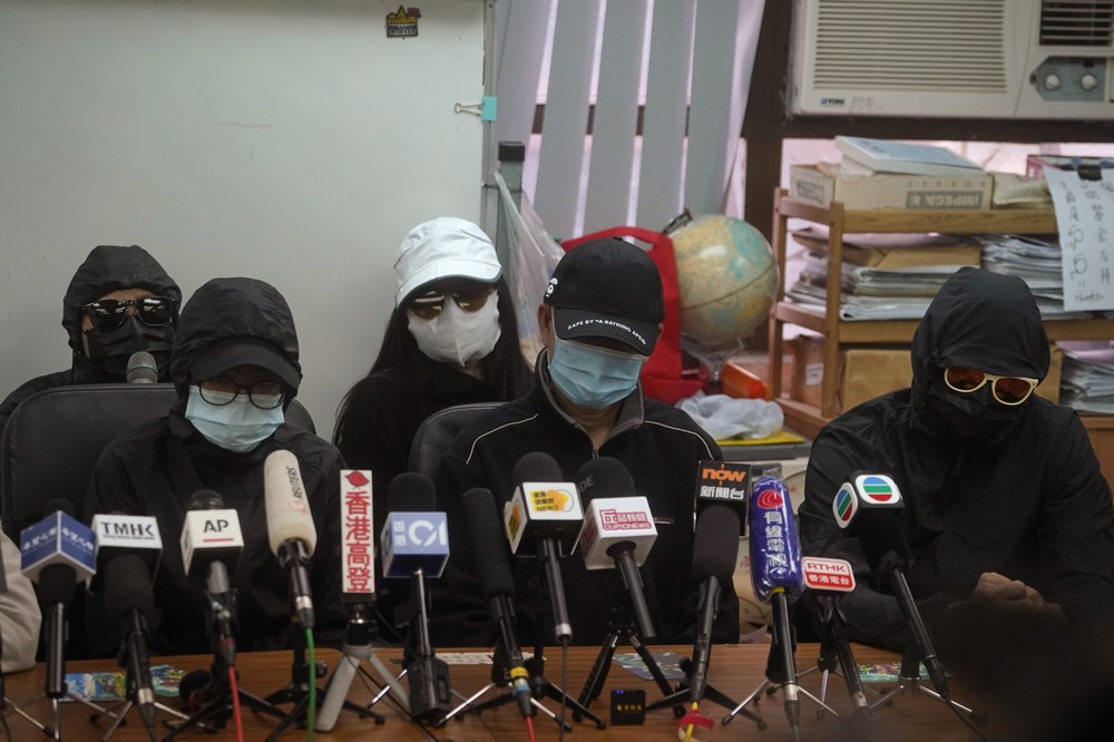Relatives of a dozen Hong Kong residents who have been detained in mainland China attend a press conference in Hong Kong, Saturday, Dec. 12, 2020. The relatives made a plea Saturday to be informed of the timing of any trials and whether they could attend.