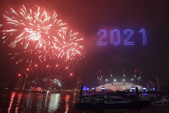 Fireworks and drones illuminate the night sky over London as they form a light display as London's normal New Year's Eve fireworks display was cancelled due to the coronavirus pandemic Thursday Dec. 31, 2020.