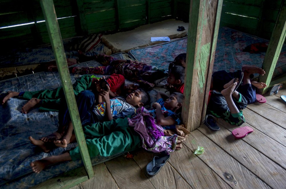 Students of a boarding school rest in their dormitory in North Kalimantan, Indonesia, on Tuesday, April 9, 2019. Some palm oil workers who work illegally in Malaysia send their children to the school in this transit town because they have no access to education in Malaysia due to their parents’ employment status.