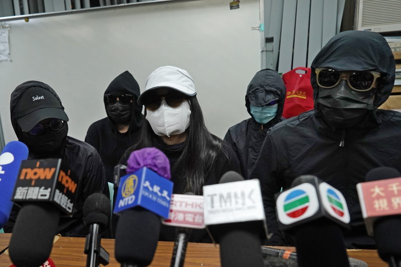 Relatives of 12 Hong Kong activists detained at sea by Chinese authorities, attend a press conference in Hong Kong, Monday, Dec. 28, 2020. Trials for 10 people accused of attempting to flee Hong Kong by speedboat amid a government crackdown on dissent got underway in China on Monday, a court official said. The defendants face charges of illegally crossing the border, while two face additional charges of organizing the attempt, according to an indictment issued in the southern city of Shenzhen. 