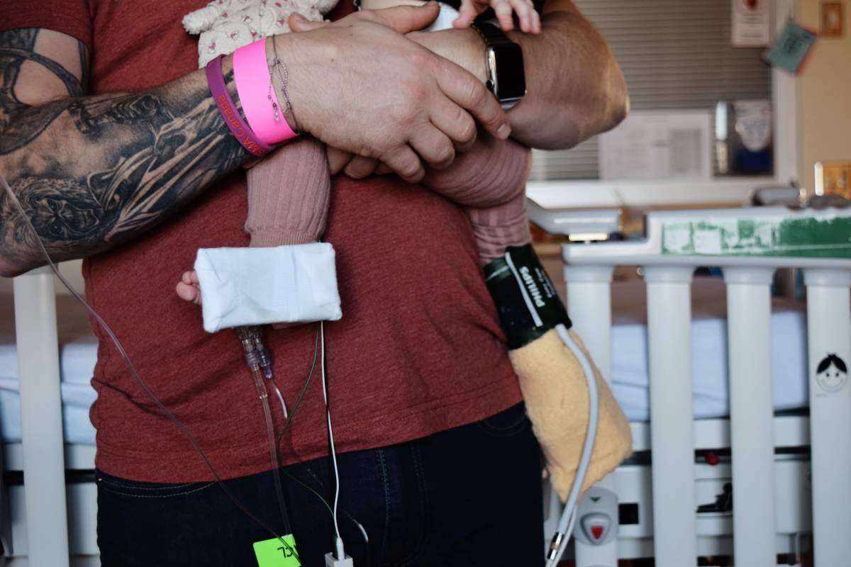 Harper Hanki, held by her dad John, receives her 60-minute IV treatment of Zolgensma, a gene therapy treatment for spinal muscular atrophy Type 1.