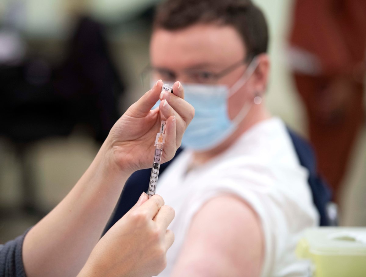 A health-care worker receiving the Pfizer-BioNTech COVID-19 vaccine in Edmonton, Alta.