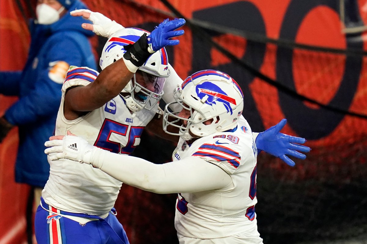Buffalo Bills defensive end Jerry Hughes, left, celebrates with teammate defensive tackle Harrison Phillips after scoring a touchdown off a fumble recovery during the second half of an NFL football game against the Denver Broncos, Saturday, Dec. 19, 2020, in Denver.