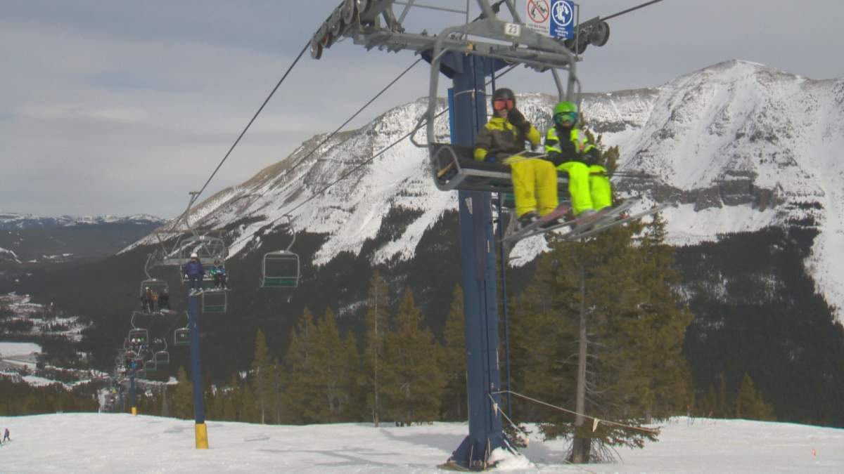 Skiers ride a lift at Castle Mountain Ski Resort in 2019.