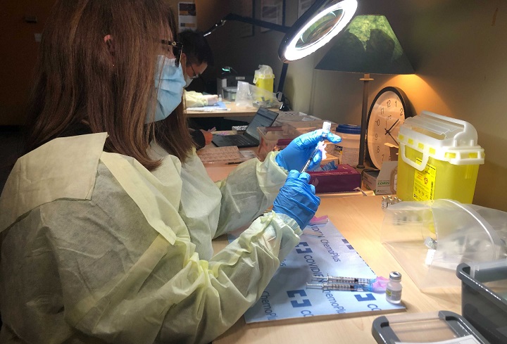 University Health Network medical staff prepare to administer the Pfizer-BioNTech COVID-19 mRNA vaccine.