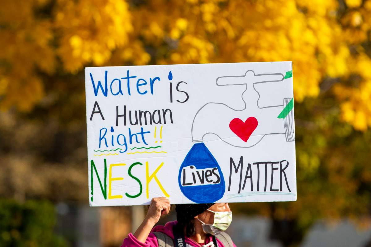 A sign is held up as people stand in solidarity with the people of Neskantaga First Nation, where residents were evacuated over tainted water last month, outside Queen’s Park in Toronto on Friday, November 6, 2020. THE CANADIAN PRESS/Carlos Osorio