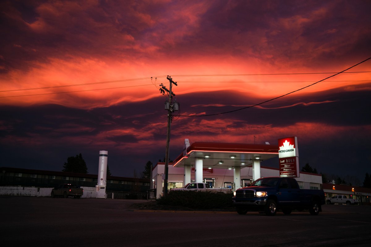 Clouds reflect the sunset over a Petro Canada gas station in Cremona, Alta., Monday, Nov. 2, 2020.
