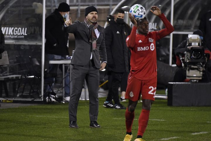Toronto FC head coach Greg Vanney, left, calls out to his team during the first half of an MLS soccer playoff match against Nashville SC, Tuesday, Nov. 24, 2020, in East Hartford, Conn.