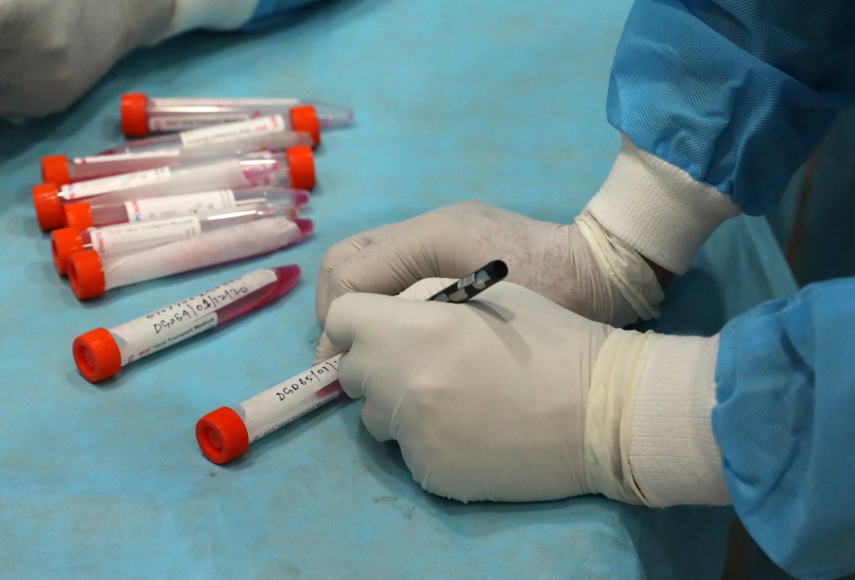 A health worker prepares vials to collect swab samples for a COVID-19 RT-PCR test in New Delhi, India, Dec. 1, 2020.