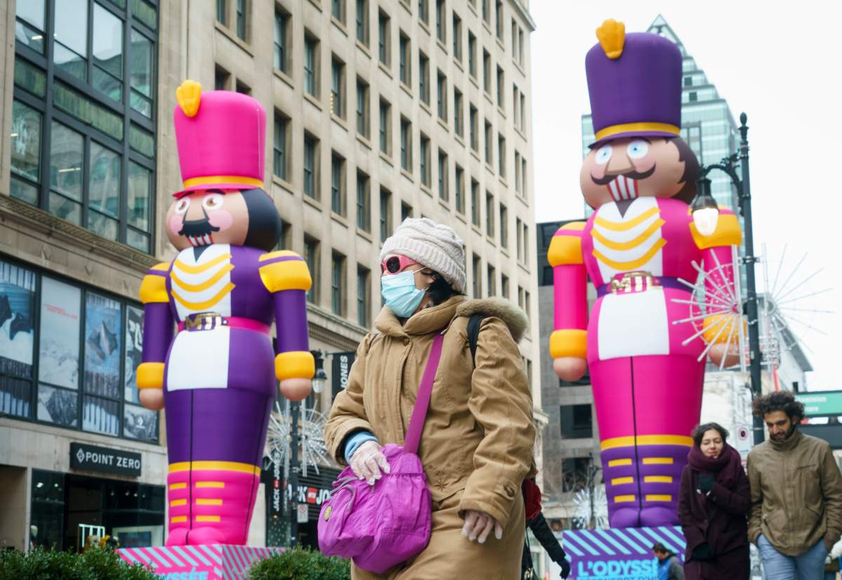 A pedestrian walks past Christmas decorations on MontrealÕs Sainte-Catherine Street, on Wednesday, December 2, 2020. 