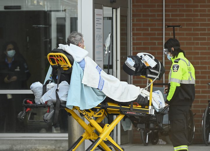 Paramedics unload a patient at an hospital emergency department in Mississauga, Ont., on Thursday, December 3, 2020. 
