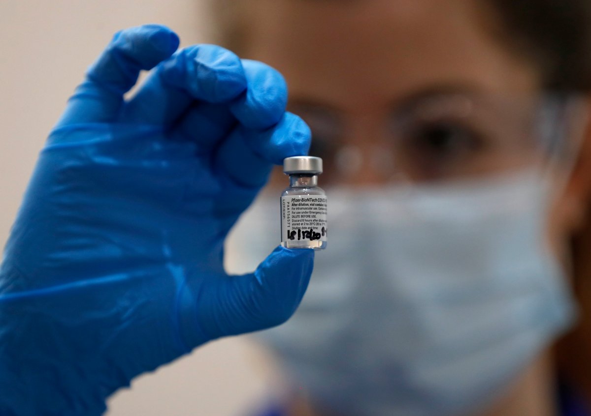 A nurse holds a phial of the Pfizer-BioNTech COVID-19 vaccine at Guy's Hospital in London, Tuesday, Dec. 8, 2020, as the U.K. health authorities rolled out a national mass vaccination program. (AP Photo/Frank Augstein, Pool)
