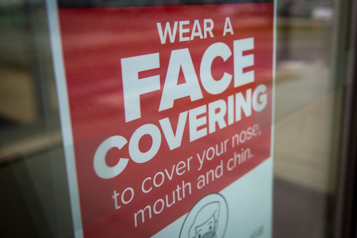 A sign advising to wear a face covering at a shopping centre.