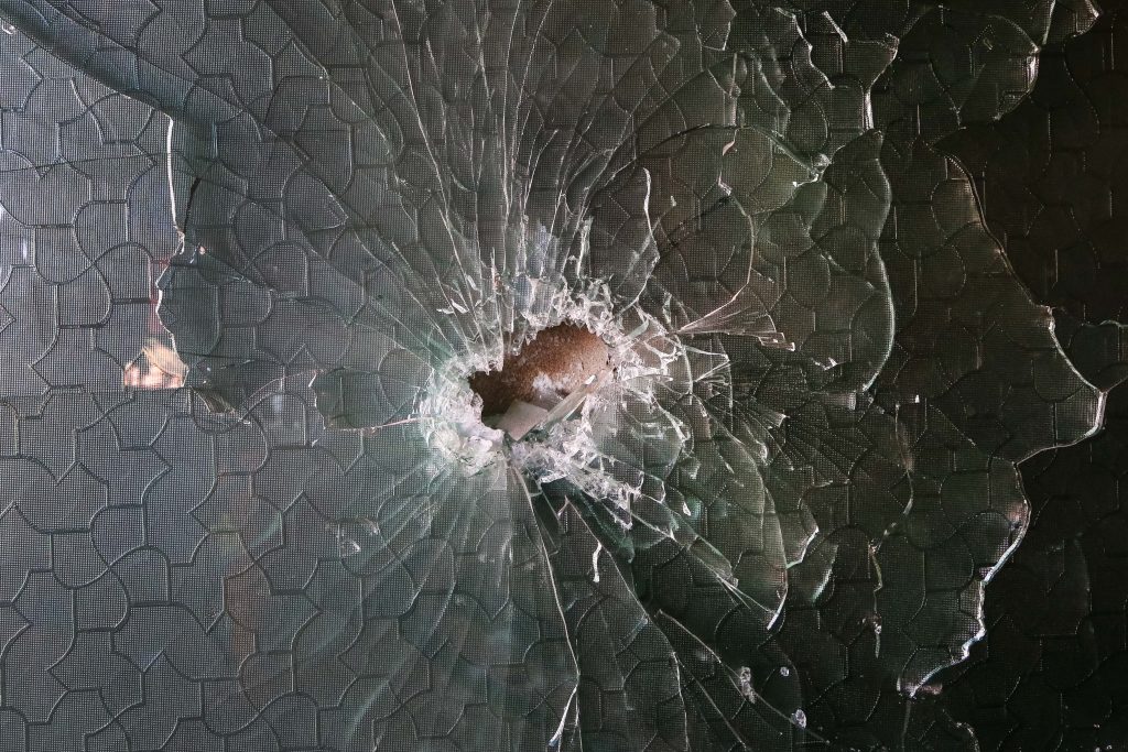 A shrapnel hole in a glass at the site of a rocket attack at a residential house in Kabul, Afghanistan, 12 December 2020. 