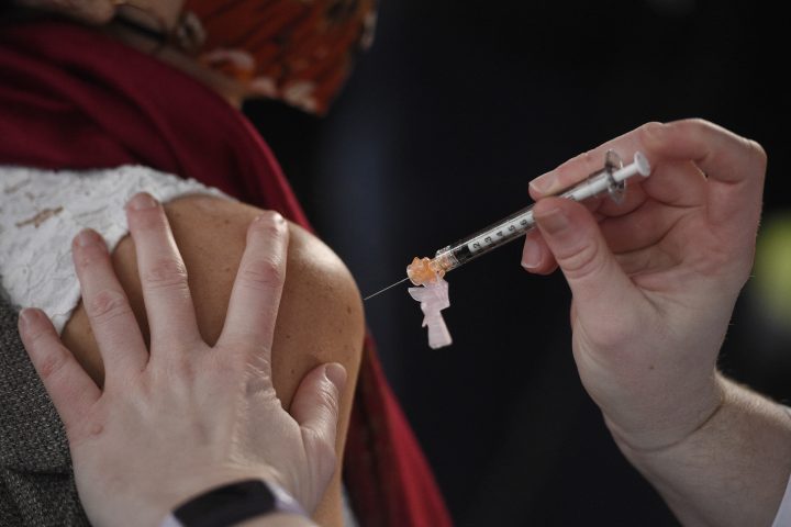 System Pharmacy Clinical Manager at Hartford HealthCare Colleen Teevan administers the Pfizer-BioNTech vaccine for COVID-19 to a front line worker outside of Hartford Hospital, Monday, Dec. 14, 2020, in Hartford, Conn.