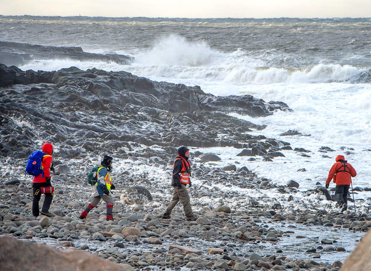 Members of a ground search and rescue team walk along the shore of the Bay of Fundy in Hillsburn, N.S. in an area where empty life-rafts from a scallop fishing vessel where reported on Tuesday, Dec. 15, 2020. Search and rescue aircraft, along with Canadian Coast Guard boats have been dispatched as well. THE CANADIAN PRESS/Andrew Vaughan