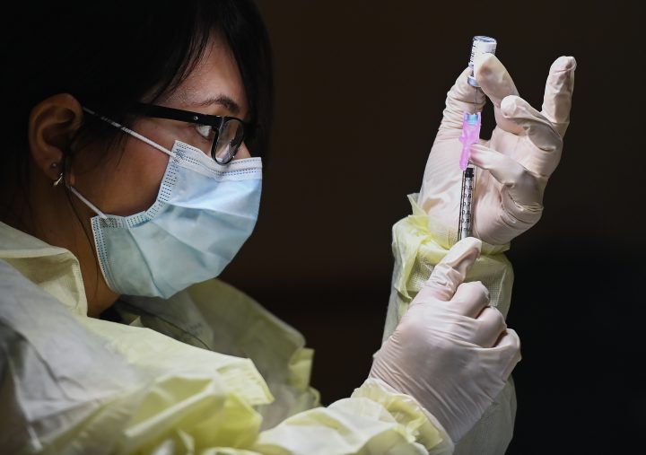 Francesca Passer, a registered pharmacist technician carefully fills the Pfizer-BioNTech COVID-19 mRNA vaccine at a vaccine clinic during the COVID-19 pandemic in Toronto on Tuesday, December 15, 2020. Toronto and Peel region continue to be in lockdown. THE CANADIAN PRESS/Nathan Denette.