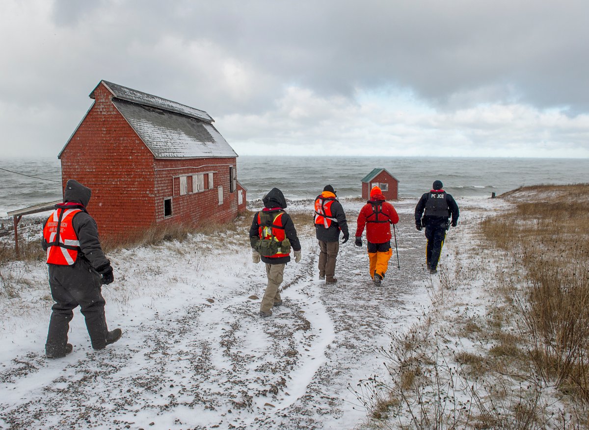Members of a ground search and rescue team walk along the shore of the Bay of Fundy in Hillsburn, N.S. as they continue the to look for five fishermen missing after the scallop dragger Chief William Saulis sank in the Bay of Fundy, on Wednesday, Dec. 16, 2020. RCAF search and rescue aircraft and Canadian Coast Guard boats have been dispatched as well. 