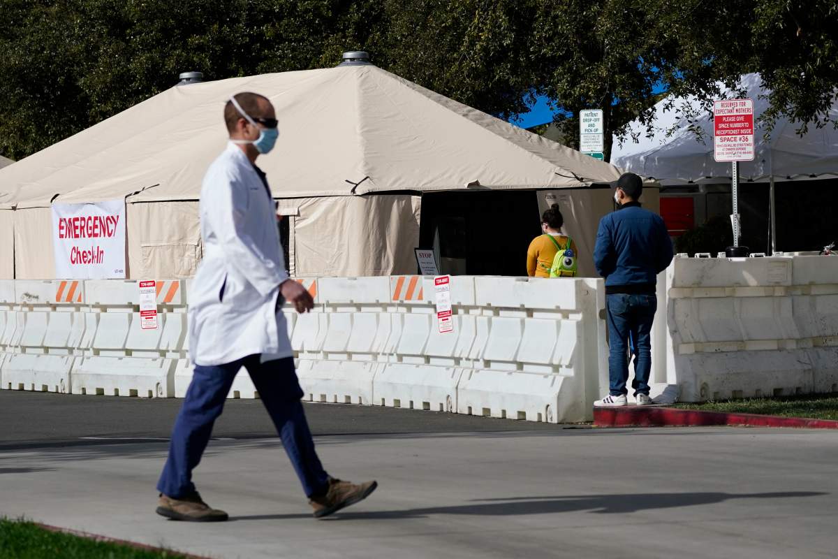 A medical worker passes a medical tent outside the emergency room at UCI Medical Center, Thursday, Dec 17, 2020, in Irvine, Calif.