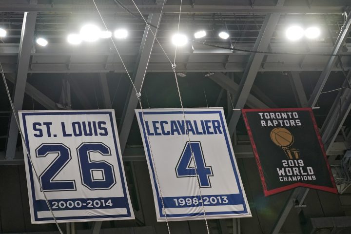 The Toronto Raptors 2019 World Championship banner hangs along with former Tampa Bay Lightning players Martin St. Louis and Vincent Lecavalier in the rafters at Amalie Arena before an NBA preseason basketball game between the Raptors and the Miami Heat Friday, Dec. 18, 2020, in Tampa, Fla. 
