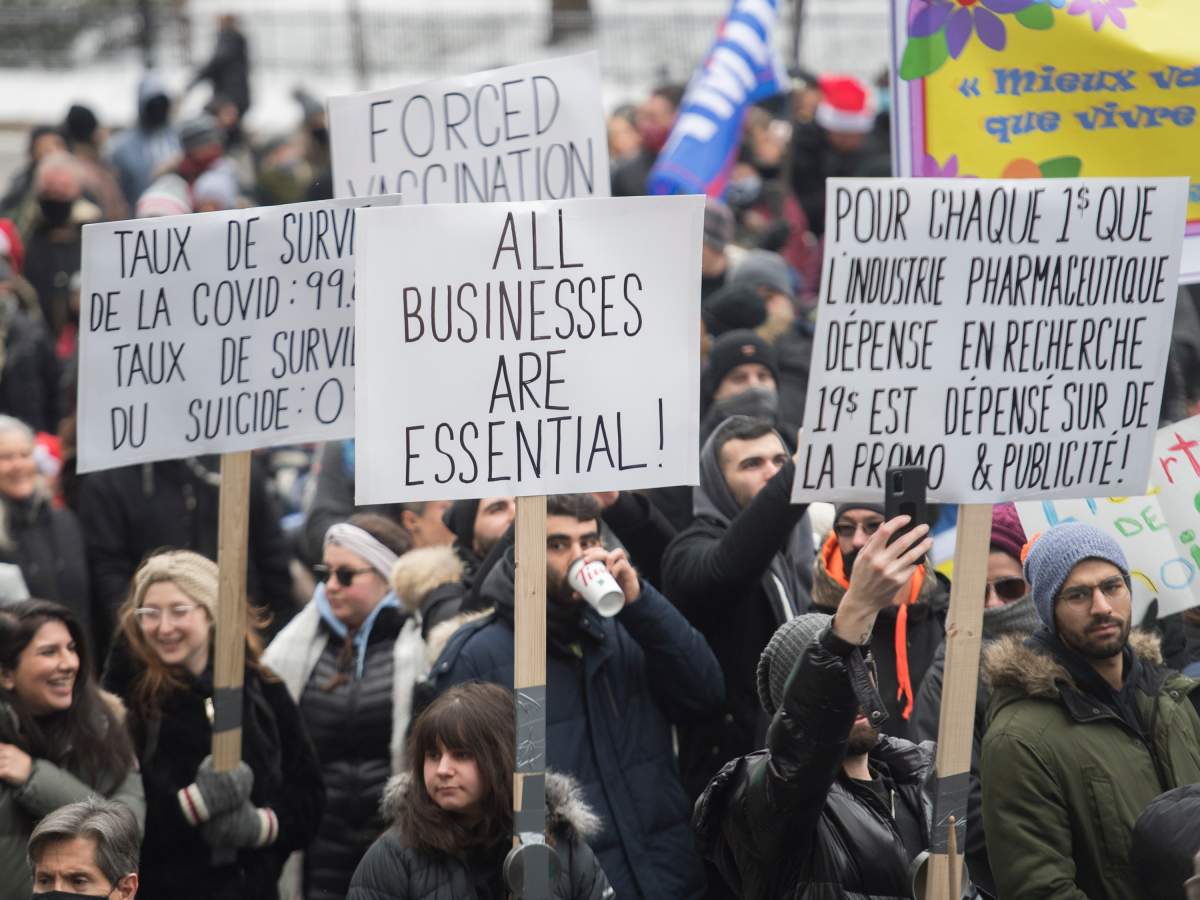 People participate in a demonstration in Montreal, Sunday, December 20, 2020, protesting measures implemented by the Quebec government to help stop the spread of COVID-19. The COVID-19 pandemic continues in Canada and around the world. 