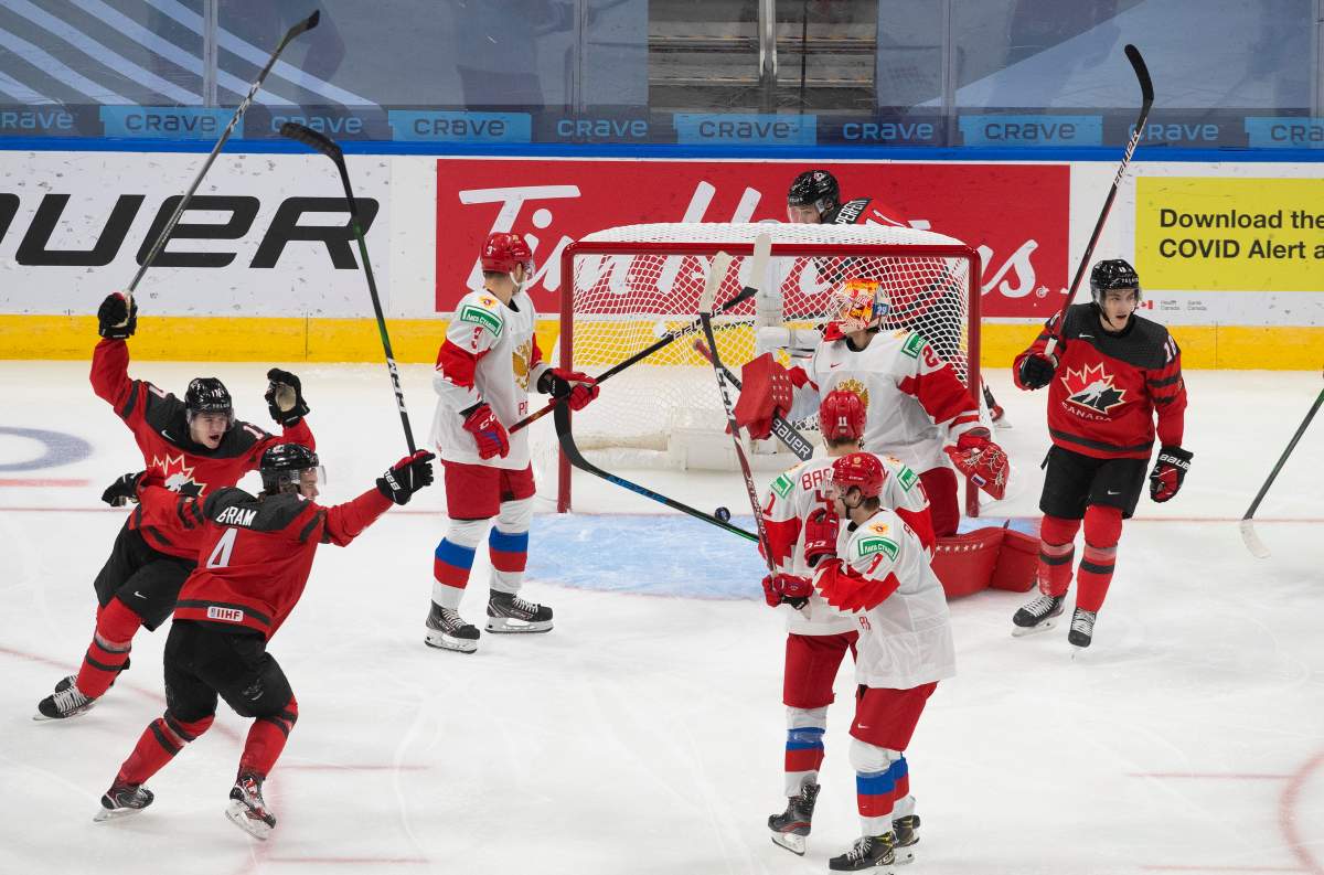 Canada's Bowen Byram (4), Connor McMichael (17) and Peyton Krebs (18) celebrate a goal against Russia's goalie Artur Akhtyamov (29) during third period IIHF World Junior Hockey Championship pre-competition action in Edmonton on Wednesday, December 23, 2020. 