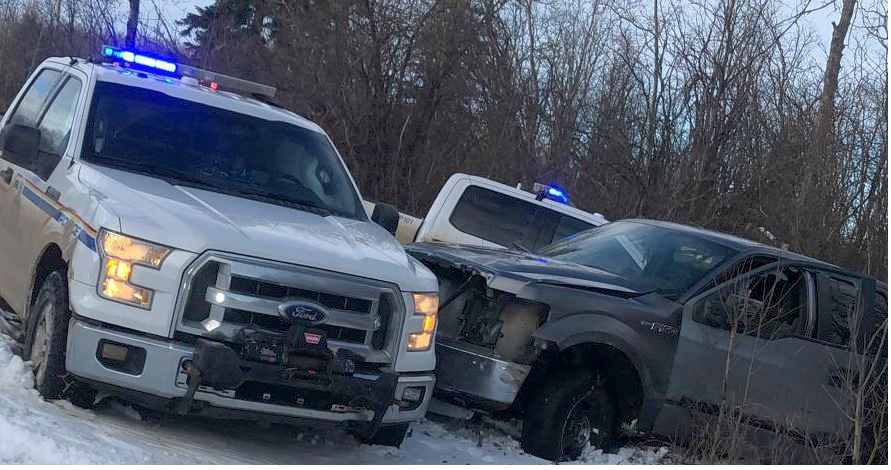 RCMP vehicles box in a truck after a chase started on the Horse Lake First Nation, Alberta on Thursday Dec. 24, 2020. Mounties in Alberta say they've arrested a man with a history of violence against police following a chase where they allege he rammed several police vehicles with his truck. 