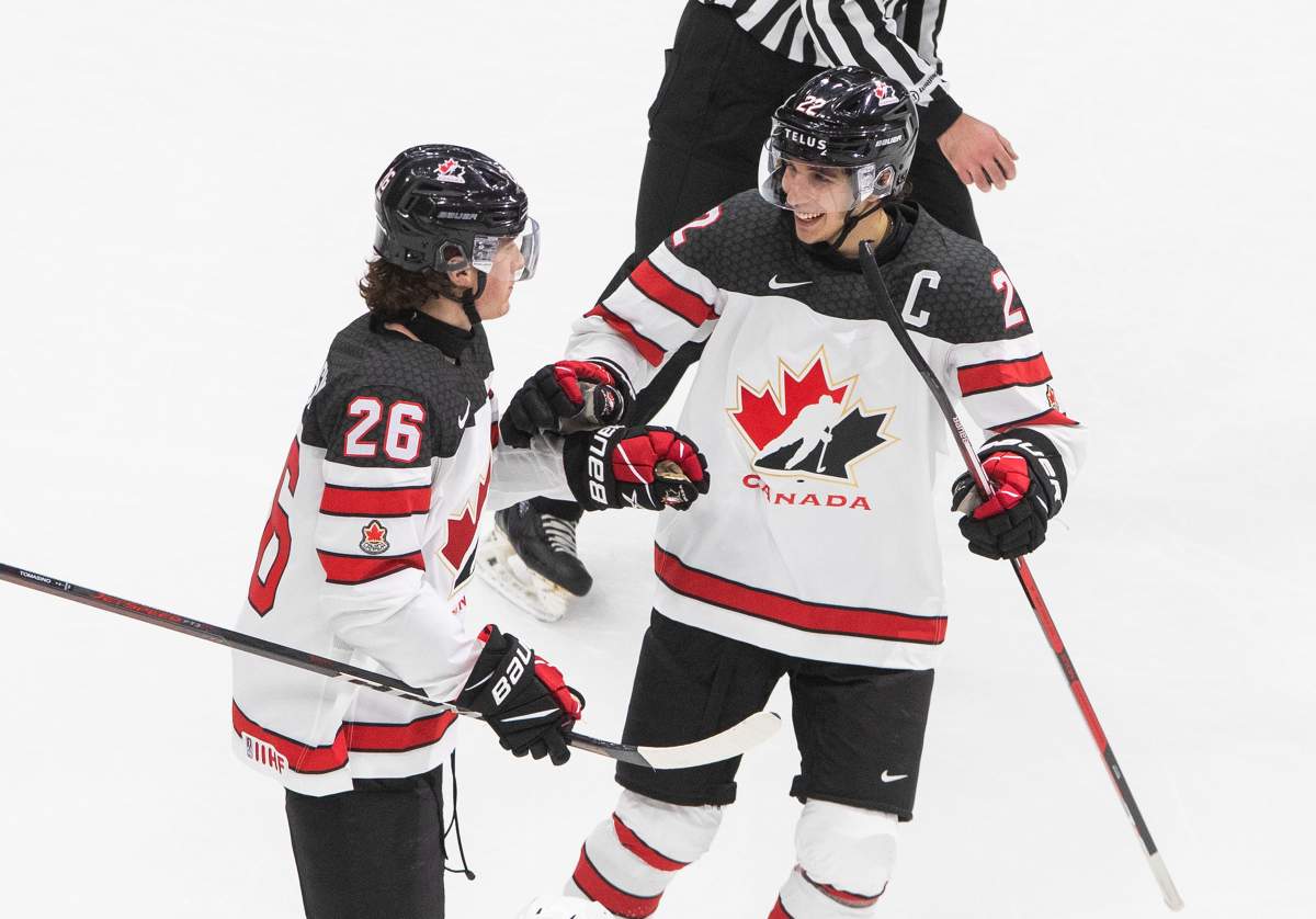 Canada's Philip Tomasino (26) celebrates his goal with teammate Dylan Cozens against Slovakia during third period IIHF World Junior Hockey Championship action in Edmonton on Sunday, December 27, 2020. 