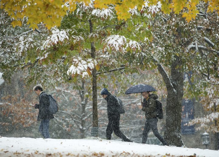 People make their way through the snow at the University of Toronto's campus in Toronto on Monday, November 11, 2019. 