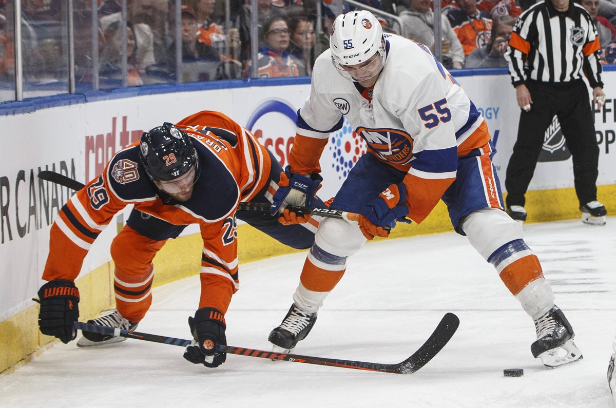 New York Islanders' Johnny Boychuk (55) and Edmonton Oilers' Leon Draisaitl (29) battle for the puck during second period NHL action in Edmonton on Thursday, Feb. 21, 2019. THE CANADIAN PRESS/Jason Franson.