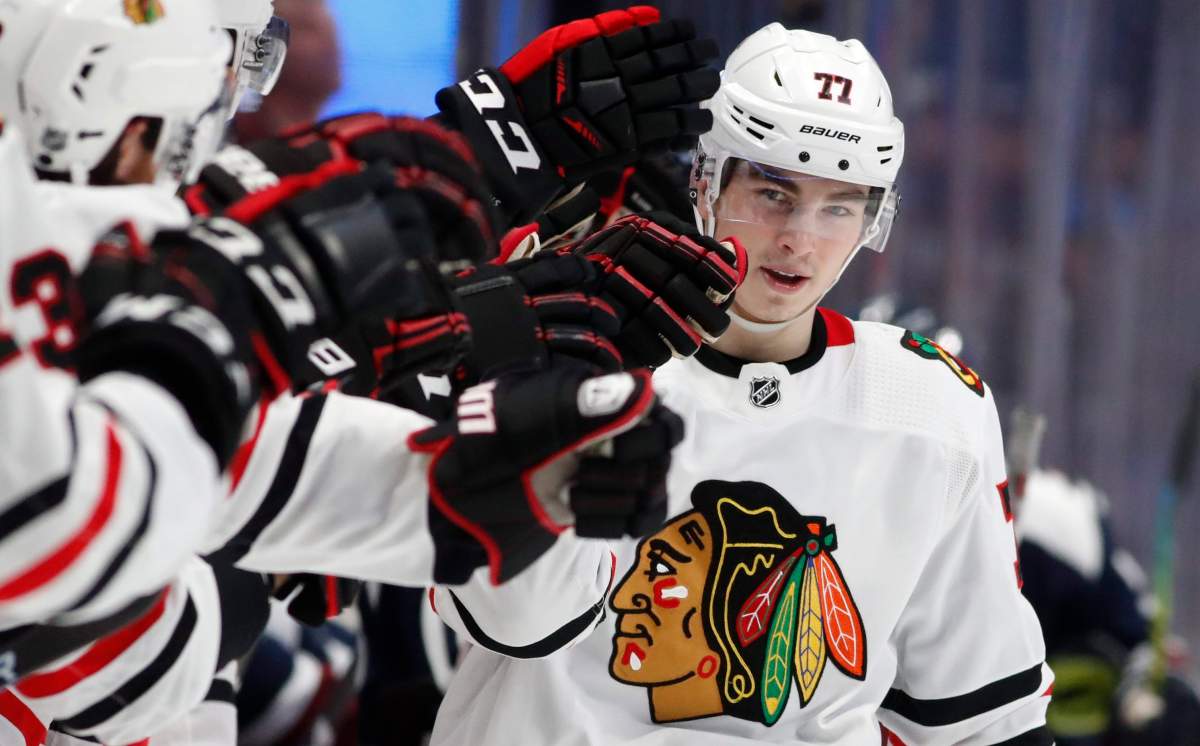 Chicago Blackhawks center Kirby Dach is congratulated as he passes the team box after scoring the tying goal against the Colorado Avalanche during the third period of an NHL hockey game Saturday, Dec. 21, 2019, in Denver. Chicago won 5-3. 