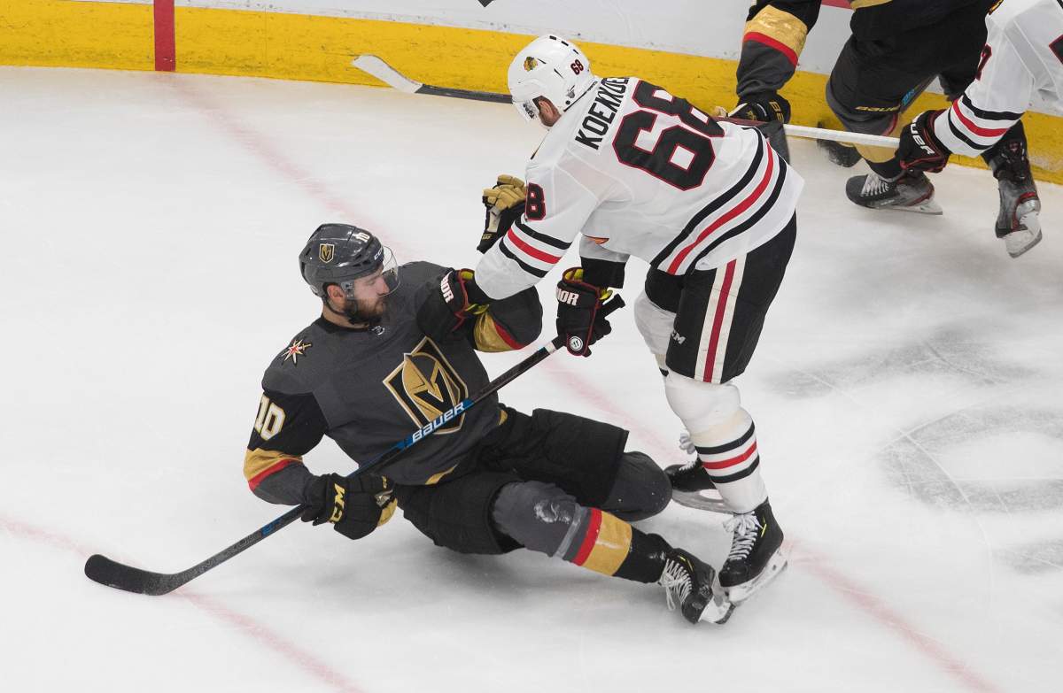 Chicago Blackhawks' Slater Koekkoek (68) checks Vegas Golden Knights' Nicolas Roy (10)during the second period of a first round NHL Stanley Cup playoff hockey series in Edmonton, on Tuesday August 11, 2020. THE CANADIAN PRESS/Jason Franson.