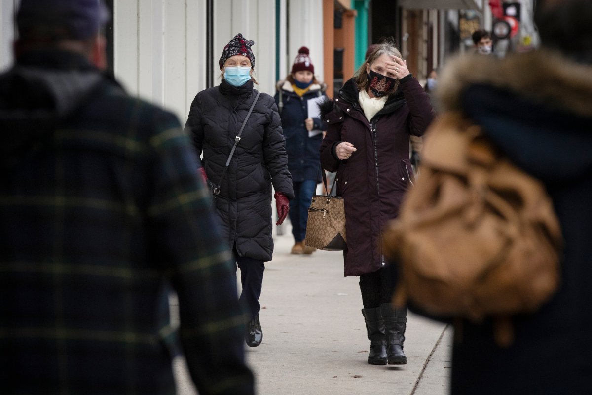 People wear masks in Kingston, Ontario on Wednesday, December 2, 2020, as the COVID-19 pandemic continues across Canada and around the world. THE CANADIAN PRESS IMAGES/Lars Hagberg.