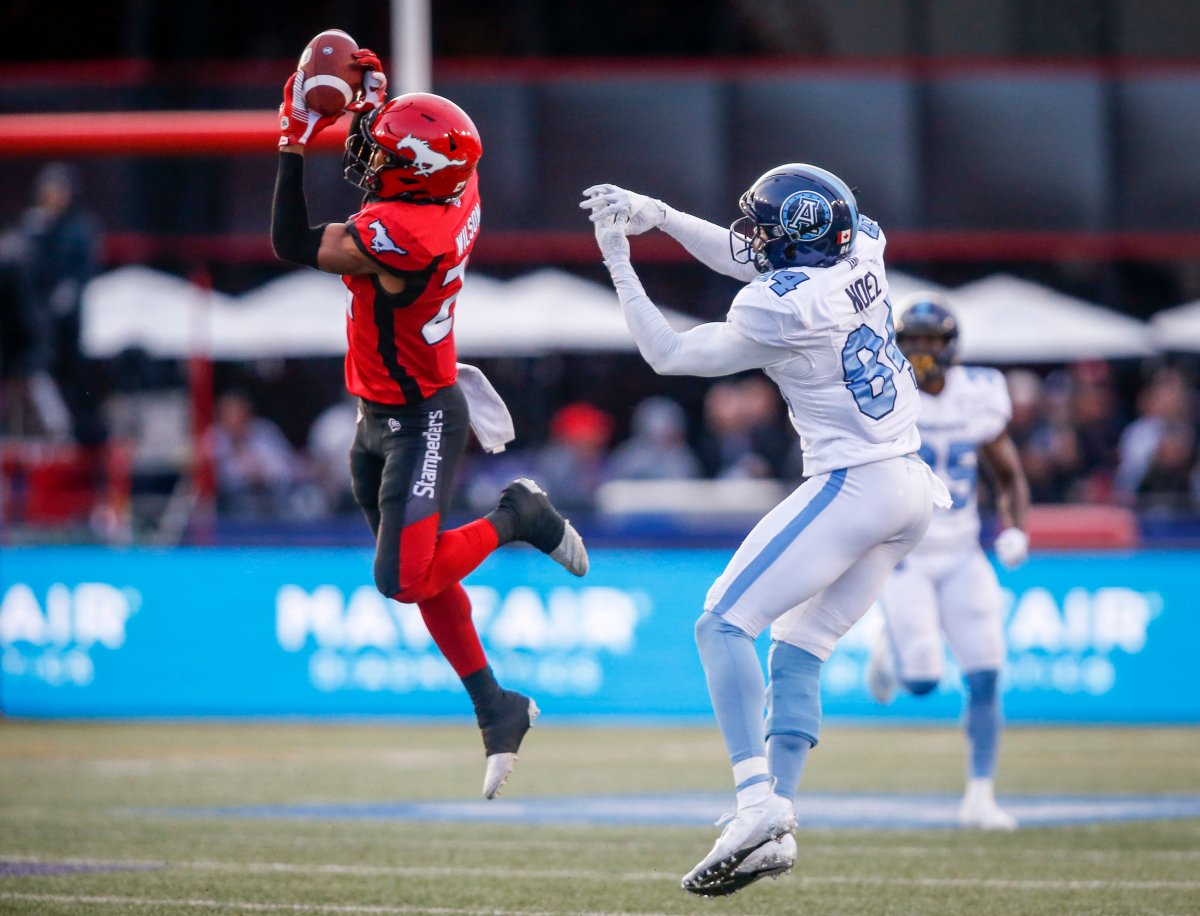 File: Toronto Argonauts' Llevi Noel, right, looks on as Calgary Stampeders' Raheem Wilson, catches a pass meant for him during second half CFL football action in Calgary, Thursday, July 18, 2019. 