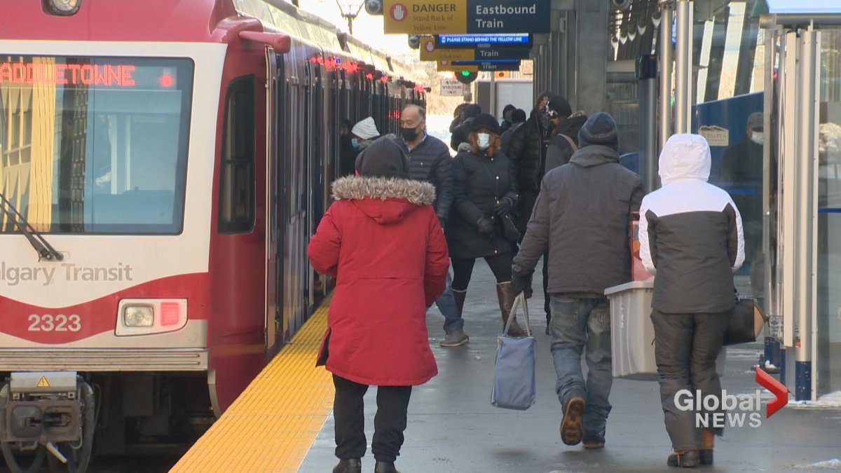 People mill about on a downtown Calgary CTrain platform on Dec. 29, 2020.