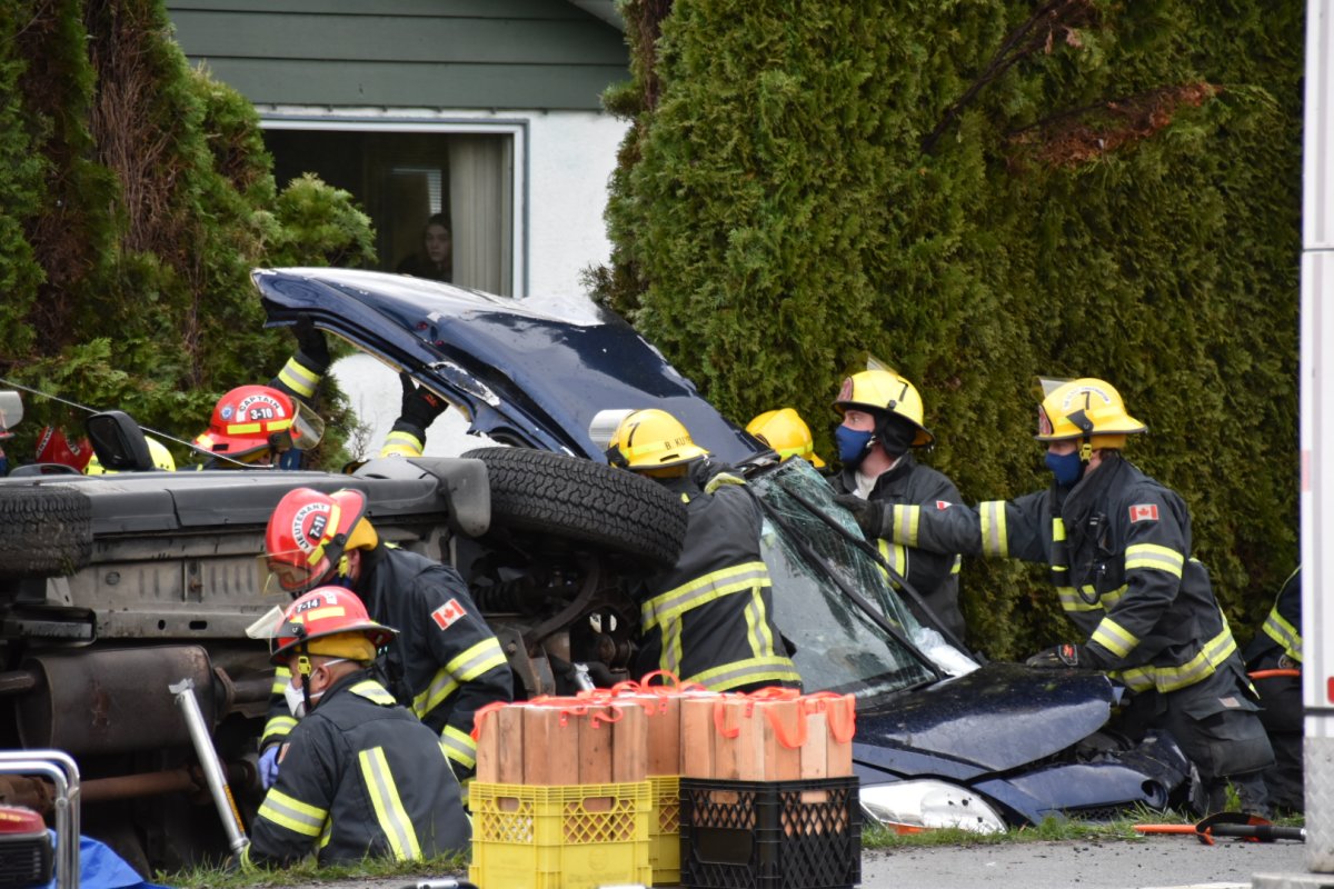 Emergency workers work to extricate a driver from one of two vehicles involved in a horrific collision at a Langley intersection Saturday afternoon.