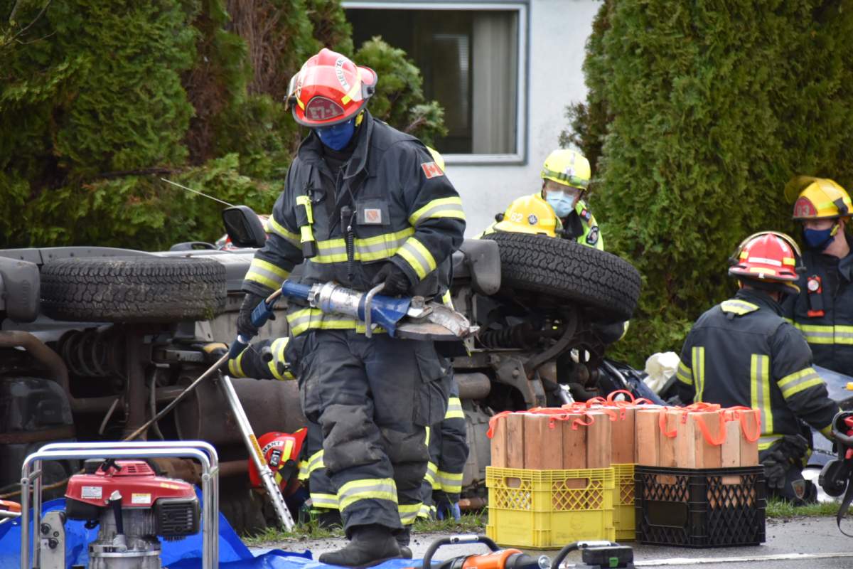Emergency workers work to extricate a driver from one of two vehicles involved in a horrific collision at a Langley intersection Saturday afternoon.