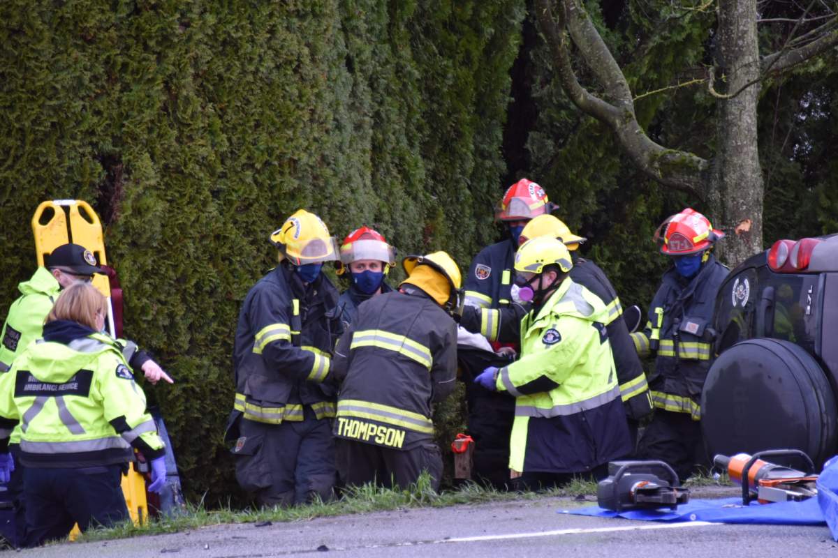 Emergency workers work to extricate a driver from one of two vehicles involved in a horrific collision at a Langley intersection Saturday afternoon.