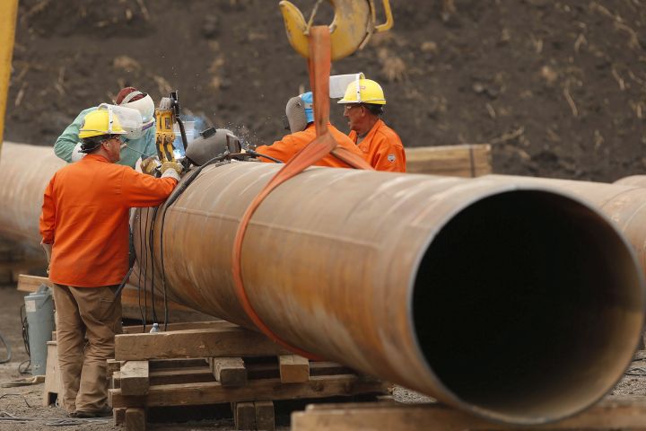 Enbridge workers weld pipe just west of Morden, Man., Thursday, Aug. 16, 2018. 