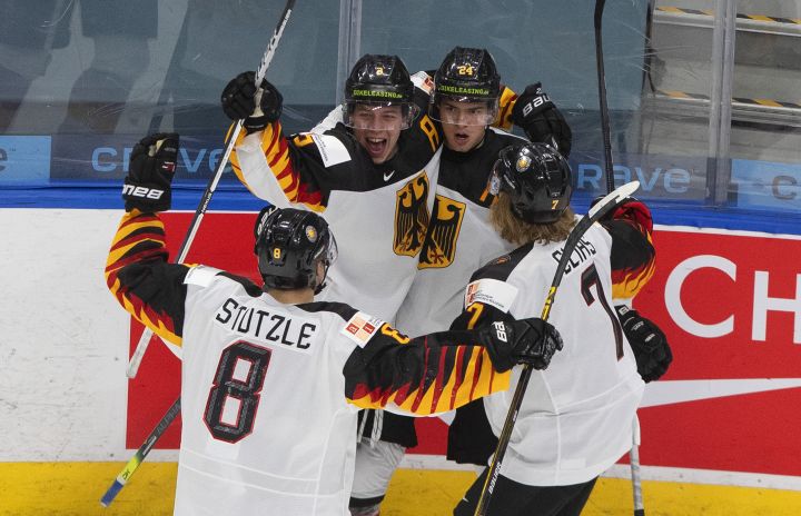Germany's Tim Stutzle (8), Simon Gnyp (3), John Peterka (24) and Florian Elias (7) celebrate a goal against Switzerland during first period IIHF World Junior Hockey Championship action in Edmonton on Wednesday, December 30, 2020. 