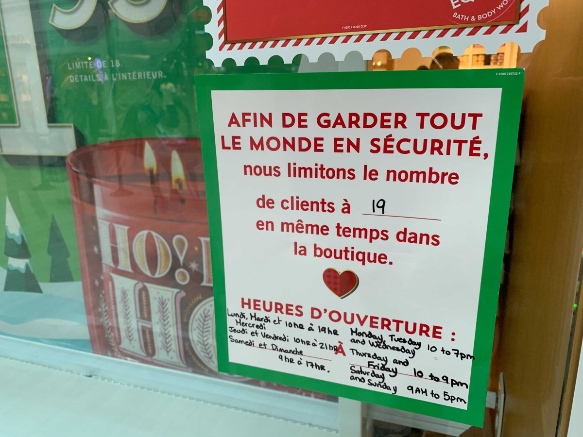 A store at Fairview Mall in Pointe-Claire, Que. lists its maximum number of clients allowed at a time during the COVID-19 pandemic.