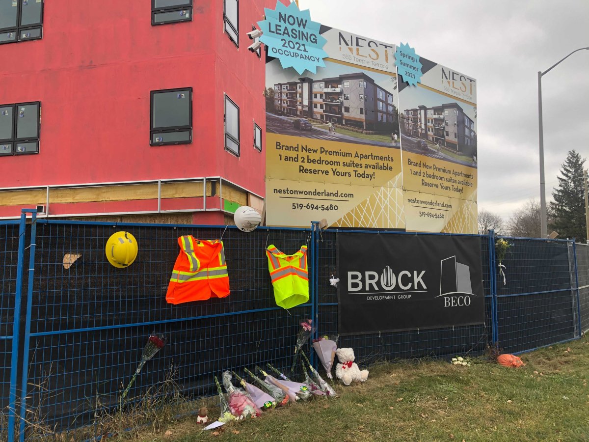 A memorial grows outside the worksite on 555 Teeple Terr. where two construction workers died following the partial collapse for a four-storey building.